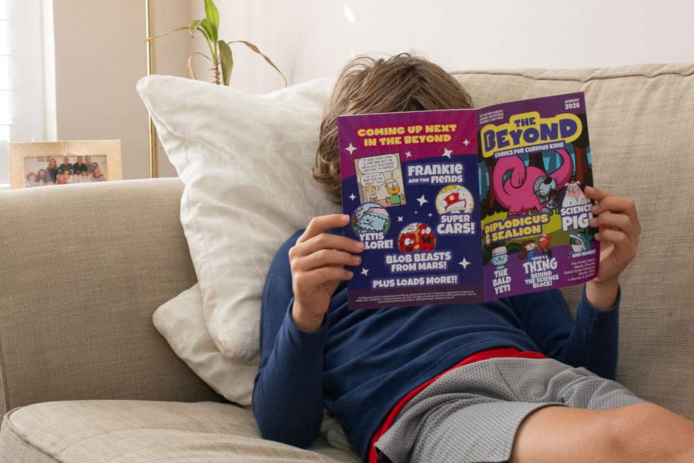 An image of a boy on a sofa reading an issue of The Beyond Comic
